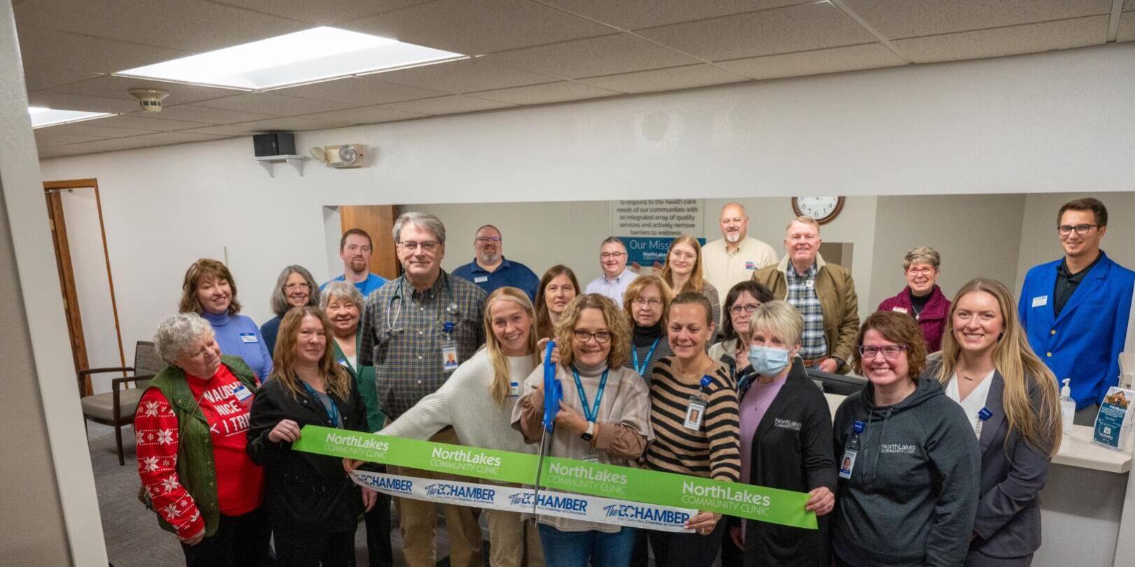 group celebrating a ribbon cutting in a health clinic